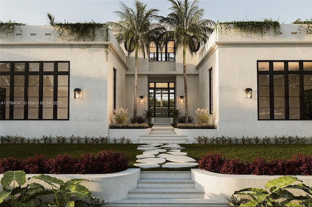 1259 NE 97th St, Miami Shores, FL 33138 - view of exterior entry featuring french doors and stucco siding