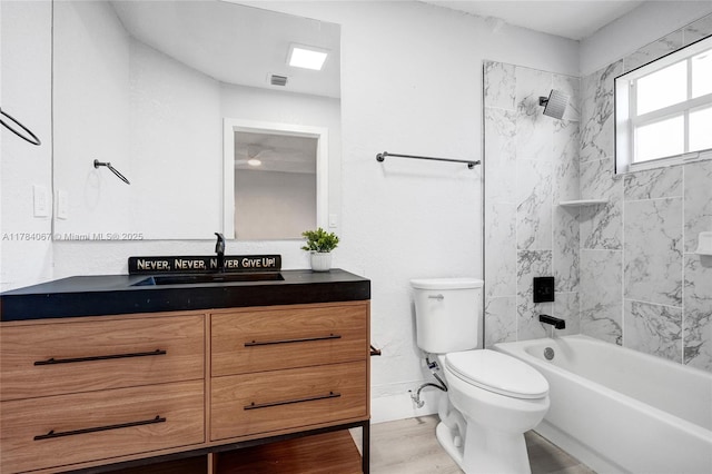 bathroom featuring visible vents, toilet, vanity, and  shower combination