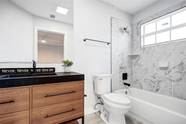 full bath with visible vents, washtub / shower combination, toilet, vanity, and wood finished floors