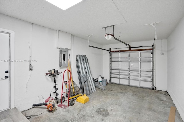 garage with a garage door opener and electric panel