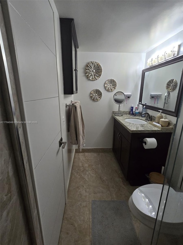 431 SE 3rd St Unit 205, Dania Beach, FL 33004 - bathroom with toilet, vanity, and baseboards