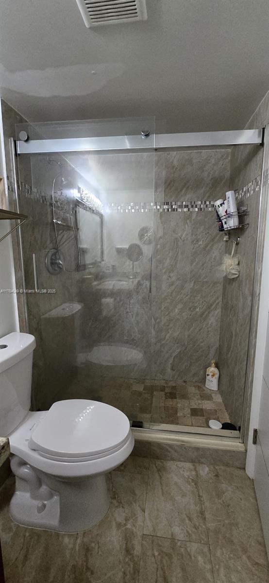 431 SE 3rd St Unit 205, Dania Beach, FL 33004 - bathroom with visible vents, toilet, and a shower stall