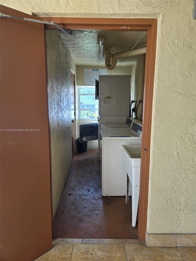 431 SE 3rd St Unit 205, Dania Beach, FL 33004 - washroom featuring separate washer and dryer, a textured wall, and a sink