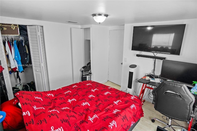 bedroom with visible vents and wood finished floors