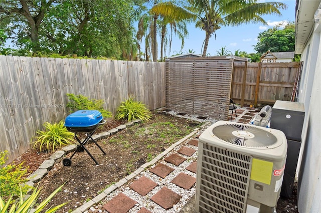 view of yard with central air condition unit and a fenced backyard