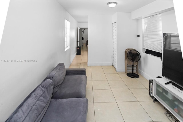 living room featuring light tile patterned floors and baseboards