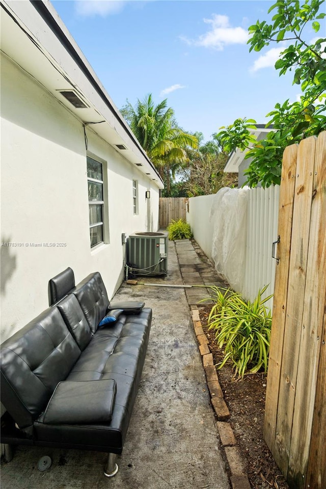 view of yard with cooling unit, a patio, an outdoor living space, and a fenced backyard