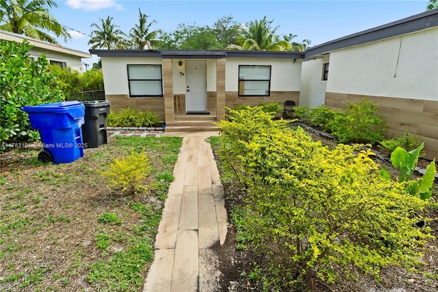 entrance to property with stucco siding