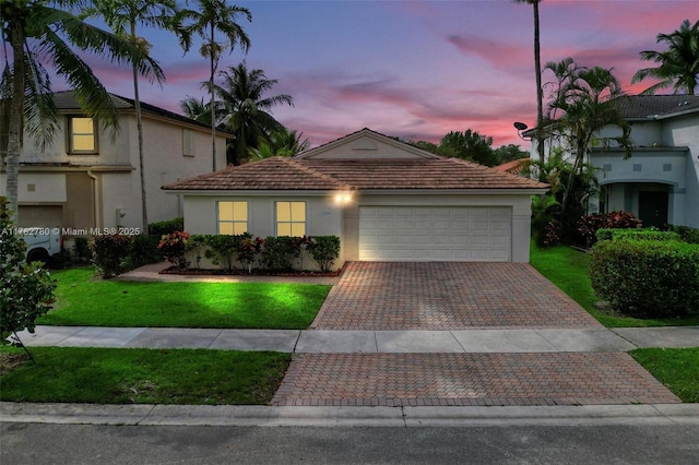 7324 NW 1st Pl, Plantation, FL 33317 - mediterranean / spanish house with a tiled roof, a lawn, a garage, stucco siding, and decorative driveway
