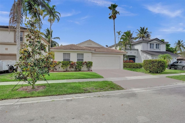 7324 NW 1st Pl, Plantation, FL 33317 - view of front of home featuring stucco siding, a front yard, a tile roof, an attached garage, and driveway