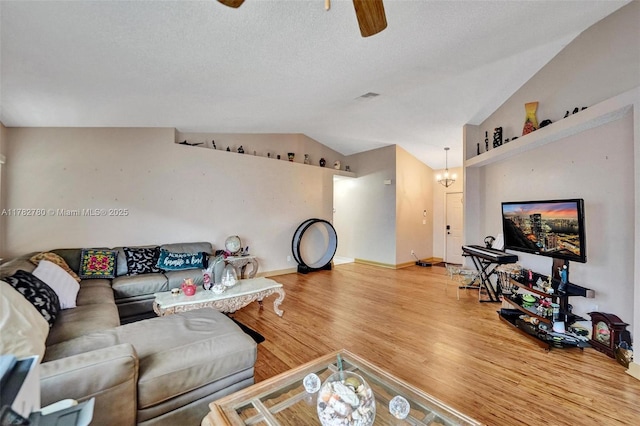 7324 NW 1st Pl, Plantation, FL 33317 - living area featuring baseboards, visible vents, lofted ceiling, ceiling fan with notable chandelier, and wood finished floors