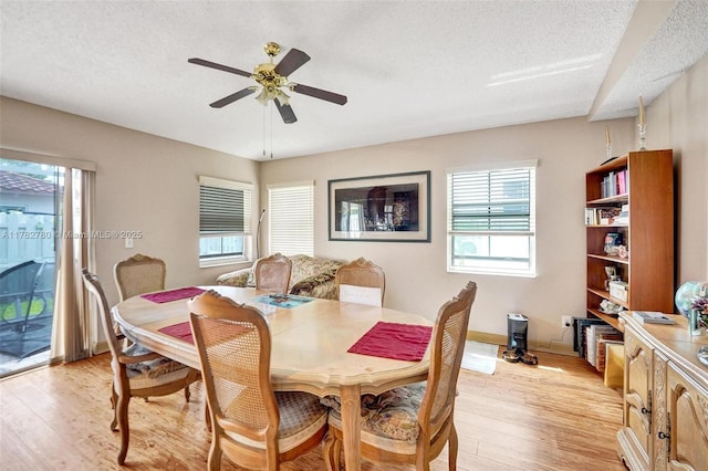 7324 NW 1st Pl, Plantation, FL 33317 - dining space with light wood-style flooring, a ceiling fan, baseboards, and a textured ceiling