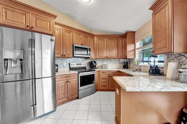 7324 NW 1st Pl, Plantation, FL 33317 - kitchen with stainless steel appliances, tasteful backsplash, a peninsula, and a sink
