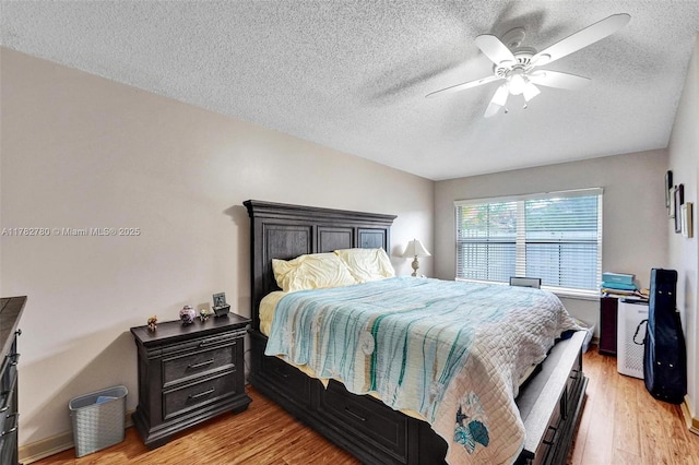 7324 NW 1st Pl, Plantation, FL 33317 - bedroom with a textured ceiling, light wood finished floors, and a ceiling fan