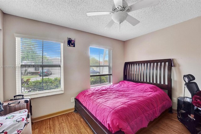 7324 NW 1st Pl, Plantation, FL 33317 - bedroom with a textured ceiling, wood finished floors, ceiling fan, and baseboards