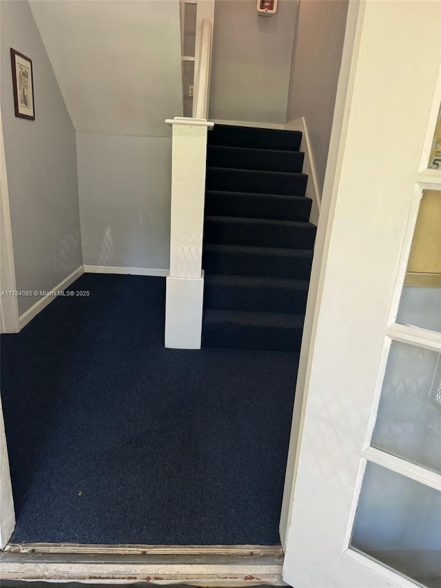 staircase with lofted ceiling