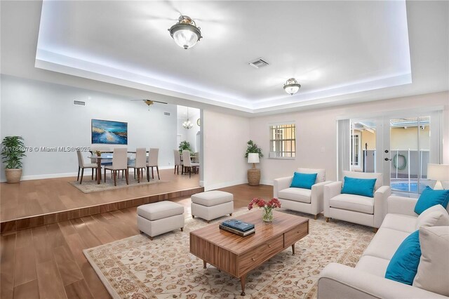 4991 NW 72nd Ter, Lauderhill, FL 33319 - living area featuring visible vents, a notable chandelier, wood finished floors, and a raised ceiling