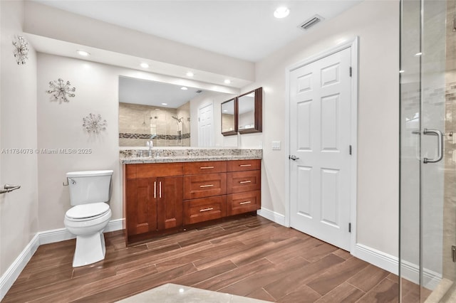 4991 NW 72nd Ter, Lauderhill, FL 33319 - full bathroom with wood tiled floor, a stall shower, vanity, baseboards, and toilet