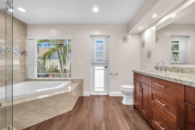 4991 NW 72nd Ter, Lauderhill, FL 33319 - bathroom featuring vanity, toilet, recessed lighting, baseboards, and a garden tub