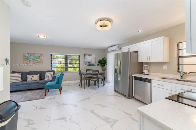 3313 SE 3rd St, Pompano Beach, FL 33062 - kitchen with stainless steel appliances, a sink, light countertops, white cabinets, and recessed lighting