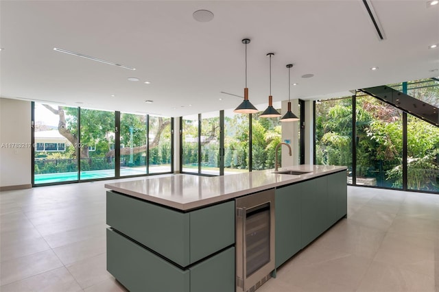 510 NE 52nd St, Miami, FL 33137 - kitchen featuring a sink, wine cooler, expansive windows, an island with sink, and open floor plan