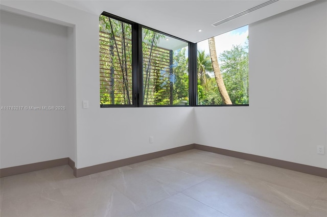 510 NE 52nd St, Miami, FL 33137 - tiled spare room featuring plenty of natural light and baseboards