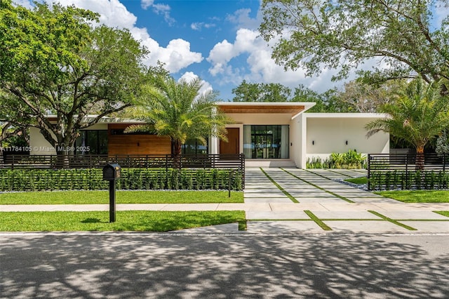 view of front of house with concrete driveway and stucco siding