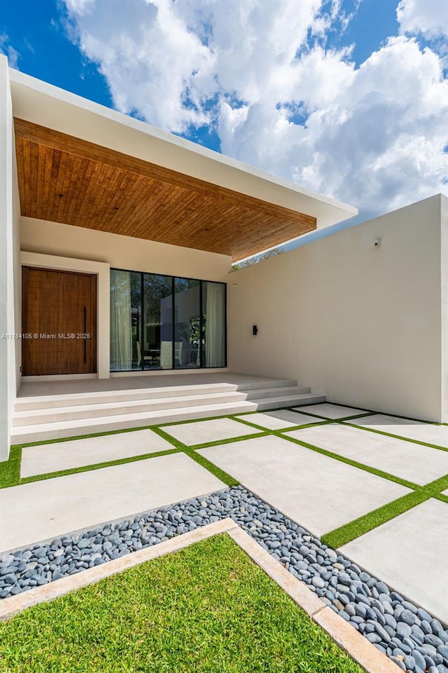 back of house featuring a patio and stucco siding