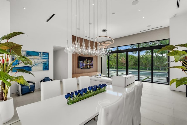 dining space with a high ceiling and light tile patterned flooring