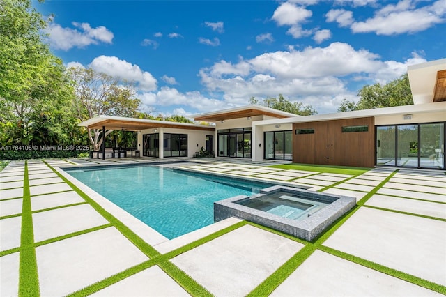 view of swimming pool featuring a patio area and a pool with connected hot tub