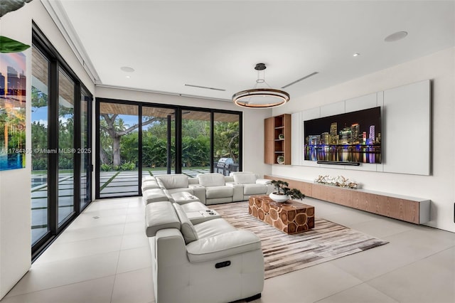 tiled living room featuring healthy amount of natural light and a chandelier