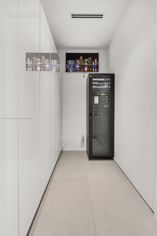 interior space with beverage cooler and light tile patterned floors