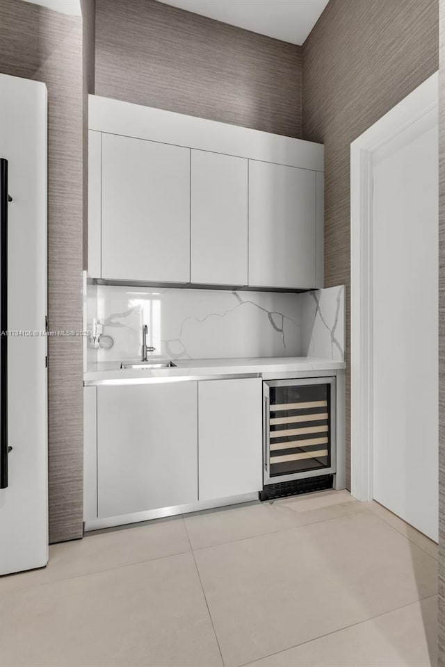 indoor bar featuring beverage cooler and light tile patterned flooring