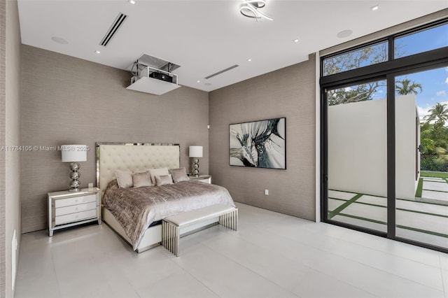 bedroom with access to outside, multiple windows, and a towering ceiling
