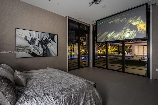 bedroom featuring concrete floors and access to outside