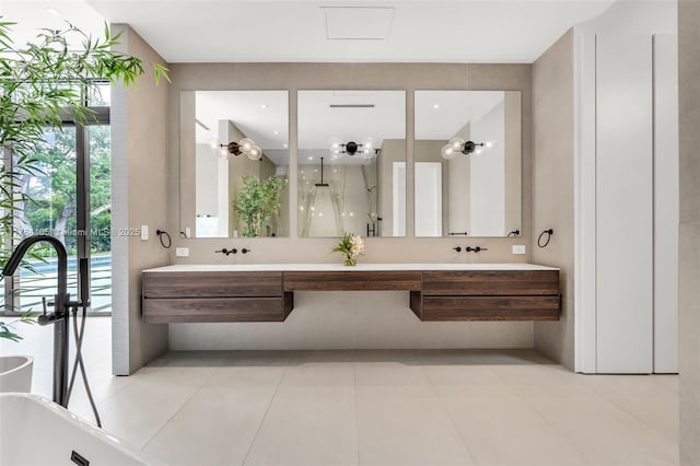 bathroom with double vanity, a freestanding bath, a shower, and healthy amount of natural light