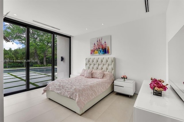 bedroom with a wall of windows, access to outside, and light tile patterned flooring