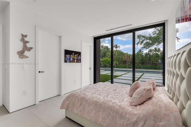 bedroom featuring access to outside and a wall of windows