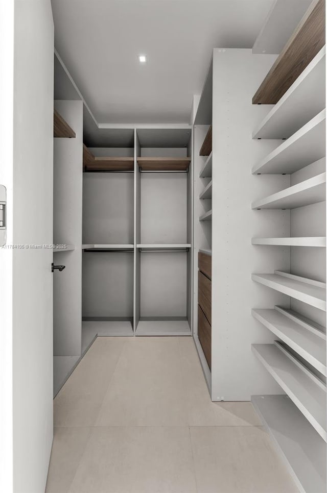 spacious closet featuring light tile patterned flooring