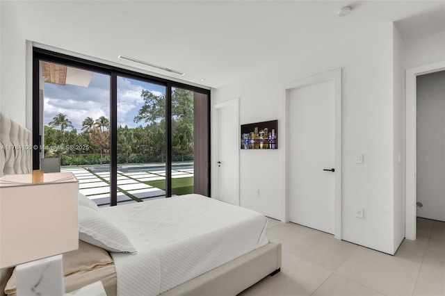 bedroom featuring expansive windows and access to outside
