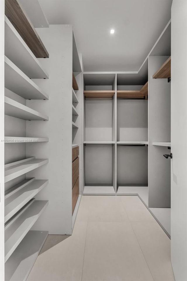 spacious closet with tile patterned floors