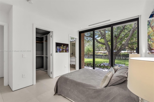 bedroom featuring a walk in closet and ensuite bath