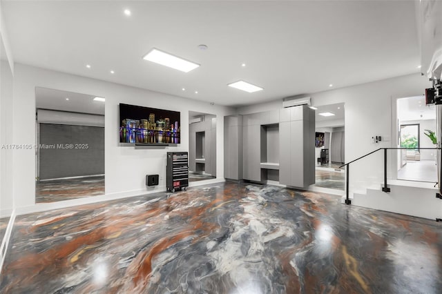 unfurnished living room with a wall unit AC and recessed lighting