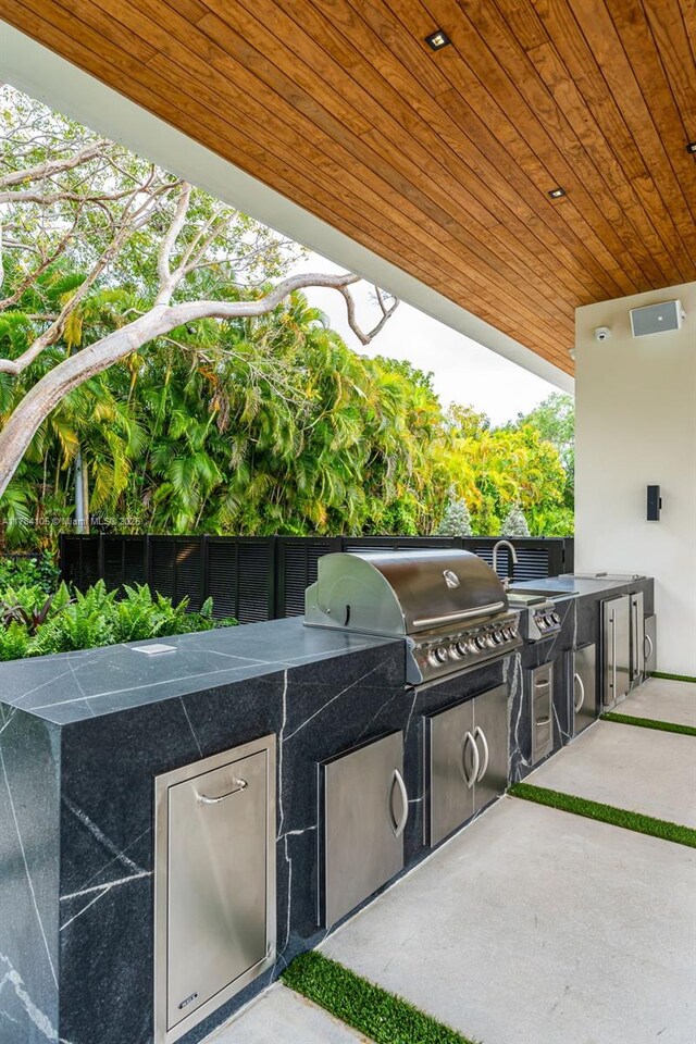 view of patio with an outdoor kitchen and area for grilling