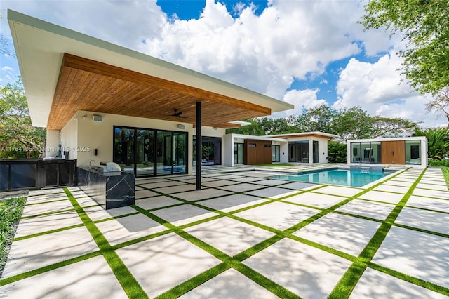 outdoor pool with a patio and a ceiling fan