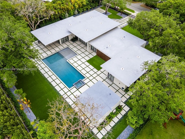 aerial view of property and surrounding area with a pool area