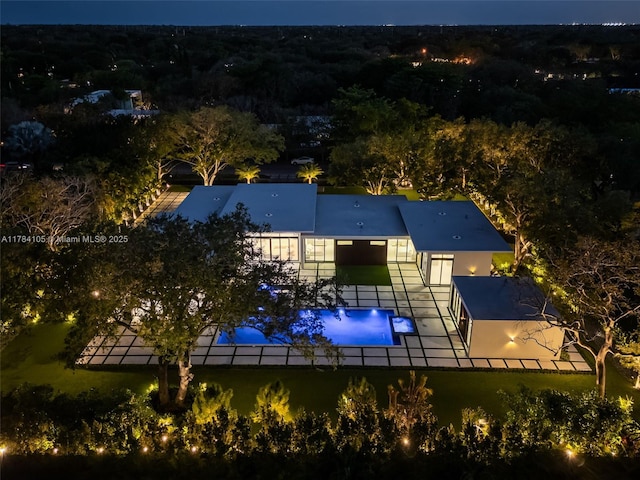 view of subject property with a pool