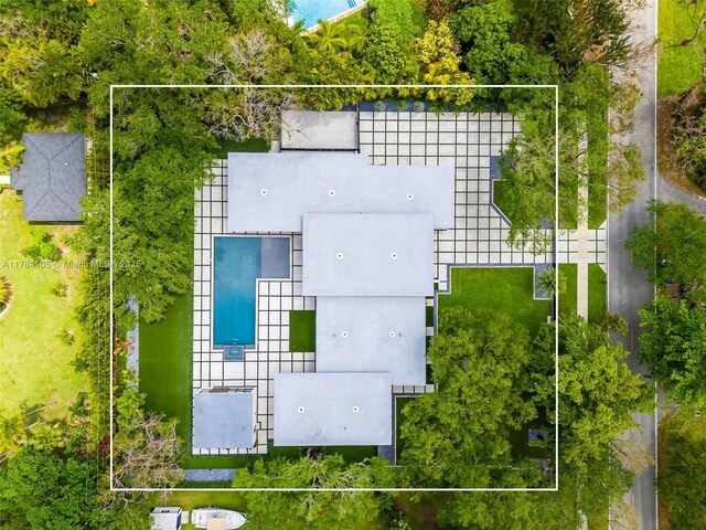 aerial view of property and surrounding area with a pool area and property parcel outlined