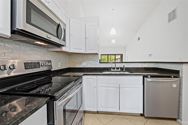 kitchen featuring visible vents, white cabinets, light tile patterned floors, a sink, and stainless steel appliances