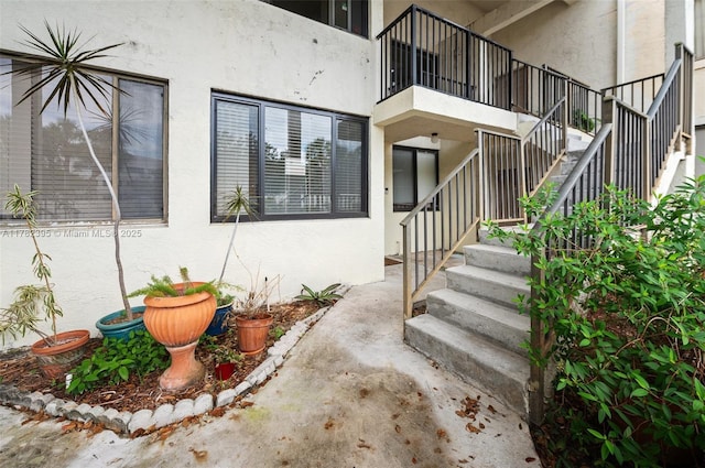 property entrance featuring stucco siding